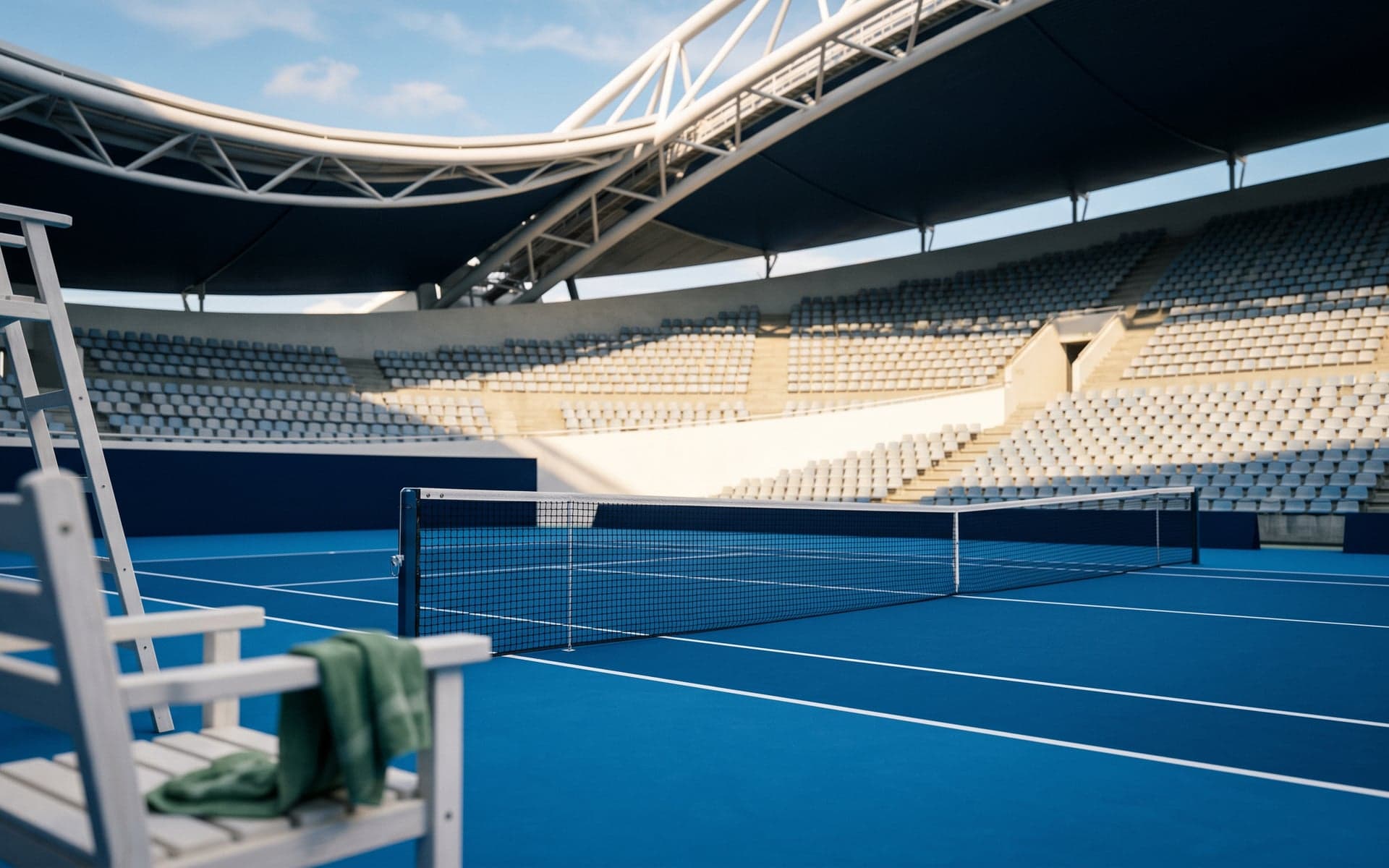 Courtside view at OAKA Centre Court — cobalt-blue surface in the foreground, white umpire chair, and the sweeping empty stadium bowl rising behind under midday Mediterranean sun.