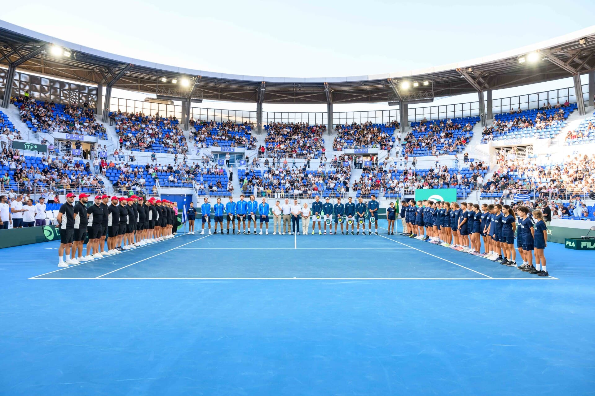 Davis Cup at OAKA, 13 September 2025 — Centre Court formation, ball kids and officials at the net before play.