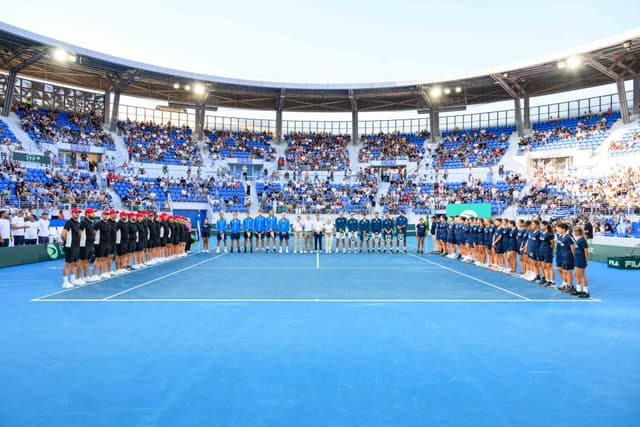 Centre Court ceremony moment — players and officials at the net.