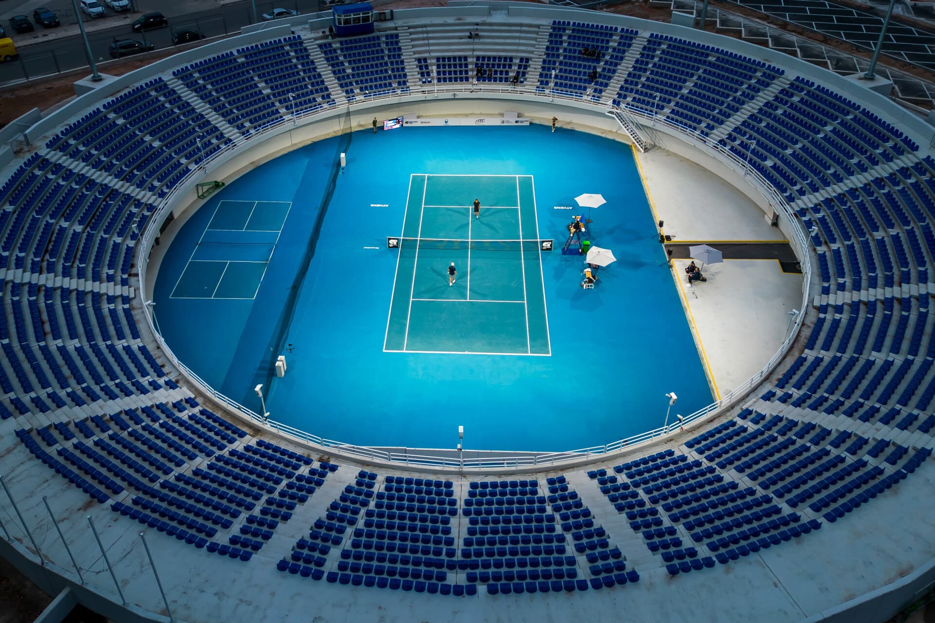OAKA Centre Court interior after the 2025 refurbishment — empty stands and new court surface.